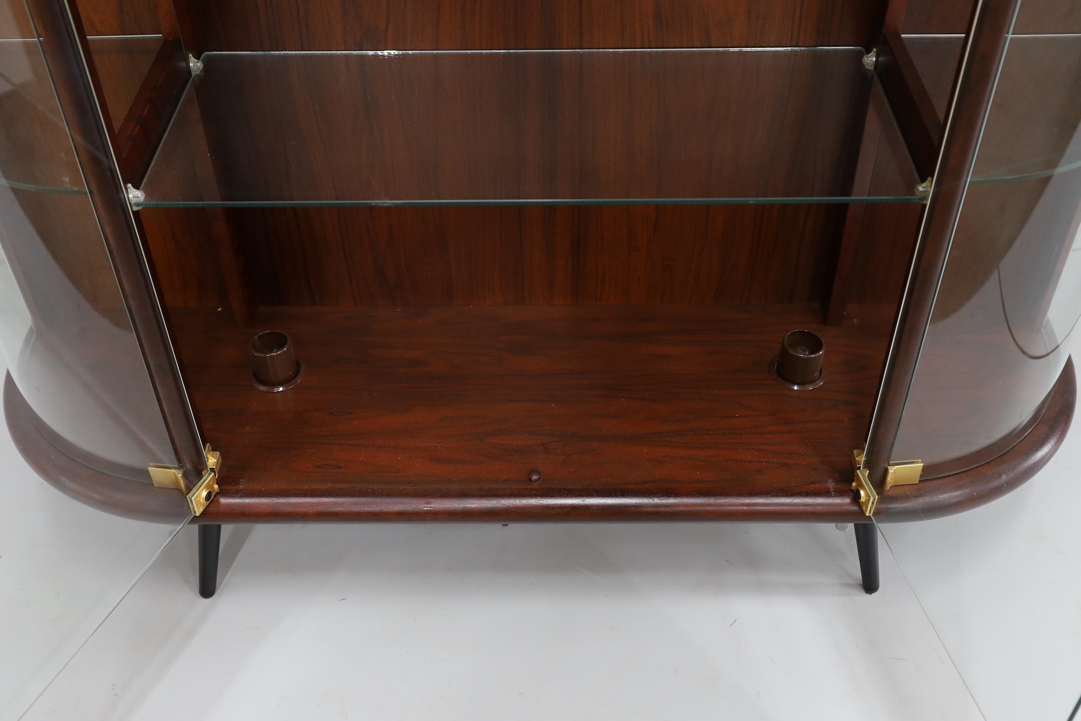 A mid century Indian rosewood glazed display cabinet with lighting, width 133cm, depth 36cm, height 130cm